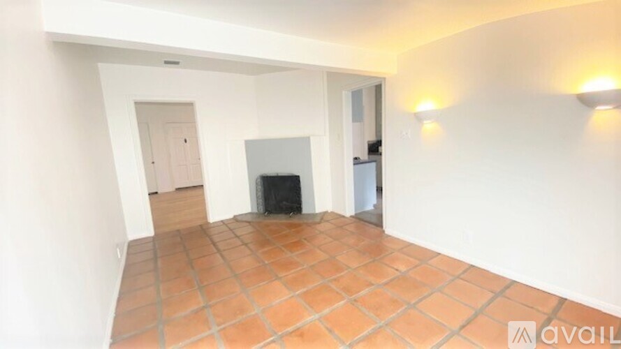 A room with a fireplace and a tiled floor.