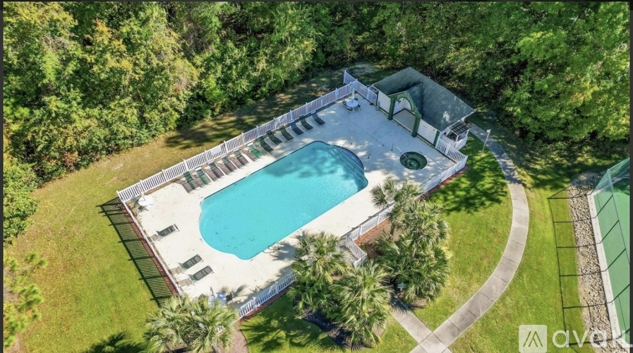 An aerial view of a house with a pool and a deck.