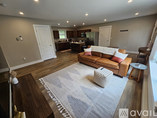A living room with a couch, a coffee table, and a rug.