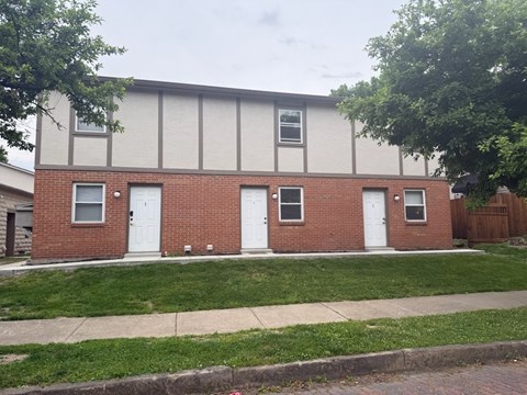 A red brick building with white doors and windows.