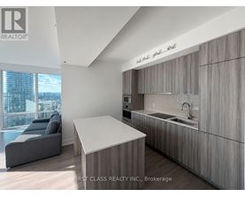 A modern kitchen with wooden cabinets and a large island.