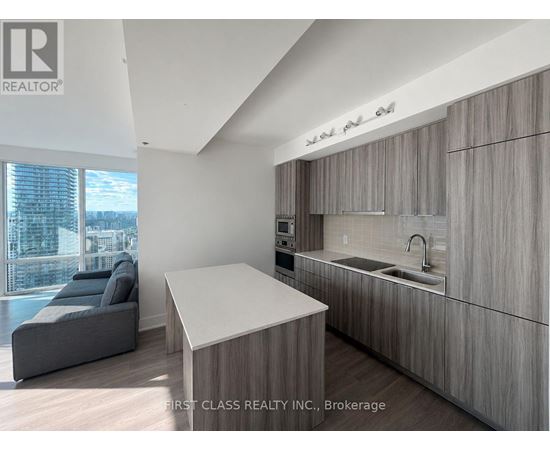 A modern kitchen with wooden cabinets and a large island.