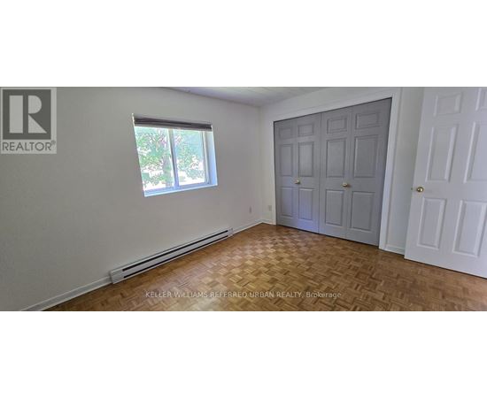 A room with a door, a window, and a wall with a logo.
