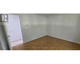 A room with a door and a wooden floor.