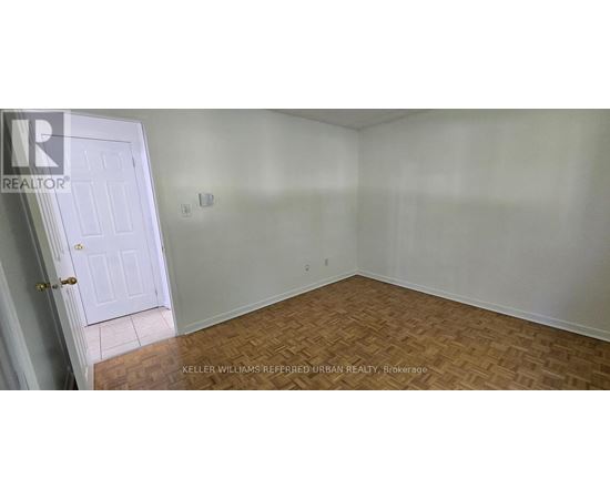 A room with a door and a wooden floor.
