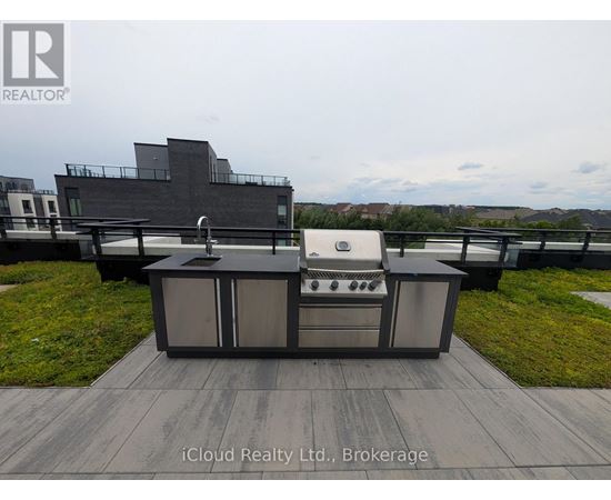 A modern outdoor kitchen setup with a grill and sink.