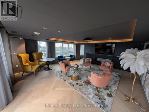 A living room with a yellow chair and a fluffy white decoration.