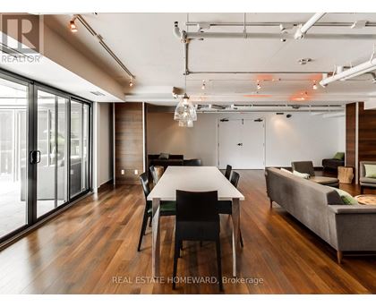 A modern dining room with a long table and chairs.