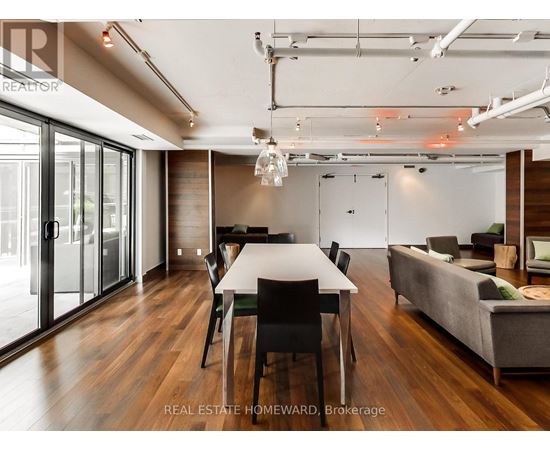 A modern dining room with a long table and chairs.