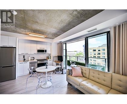 A modern kitchen with a dining table and a couch.