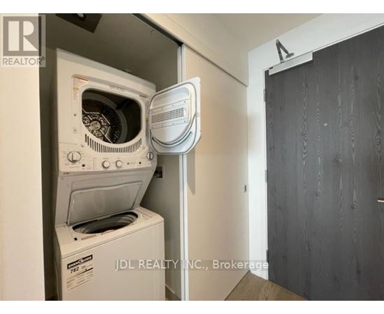 A white oven and microwave are installed in a kitchen.