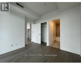 A spacious room with a doorway leading to another room.