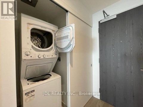 A white oven and microwave are installed in a kitchen.