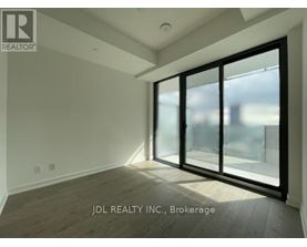 A room with a large window and sliding glass doors.
