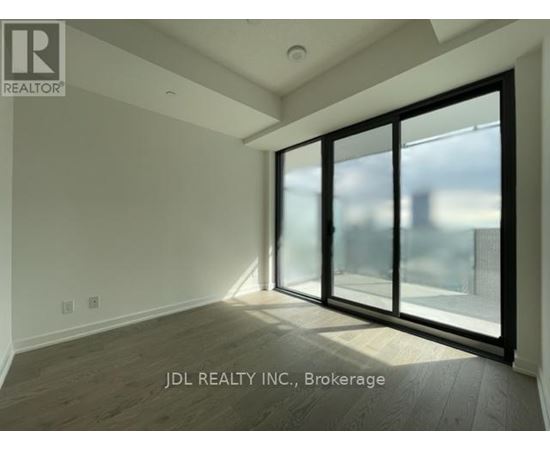 A room with a large window and sliding glass doors.