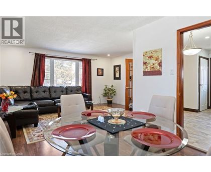 A dining room with a glass table and chairs.