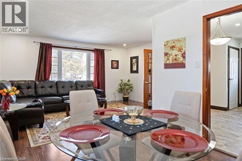 A dining room with a glass table and chairs.
