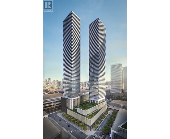 Two tall buildings with a green space in between them.