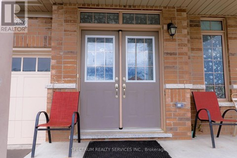 A house entrance with a glass door and two red chairs.