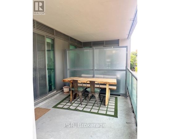A table and chairs are set up on a balcony.