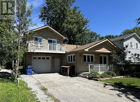 A two-story house with a garage and a driveway.