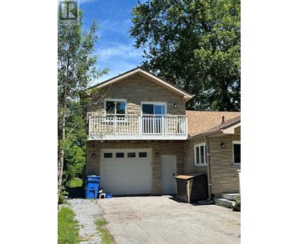 A house with a garage and a balcony.