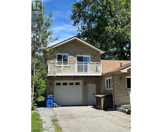 A house with a garage and a balcony.