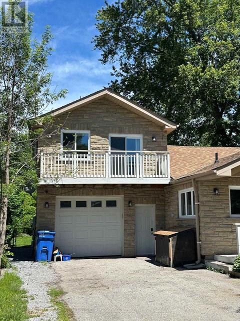 A house with a garage and a balcony.