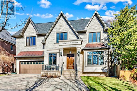 A large, two-story house with a garage and a front porch.