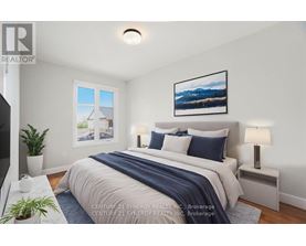 A bedroom with a bed, nightstands, and a painting on the wall.