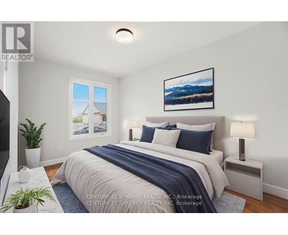 A bedroom with a bed, nightstands, and a painting on the wall.