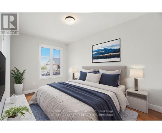 A bedroom with a bed, nightstands, and a painting on the wall.