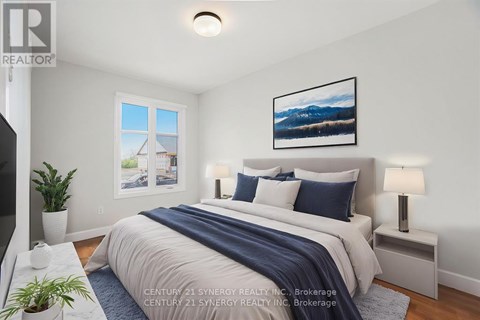 A bedroom with a bed, nightstands, and a painting on the wall.
