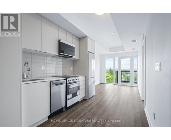 A modern kitchen with white cabinets and stainless steel appliances.