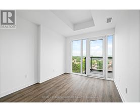 A white room with a sliding glass door leading to a balcony.