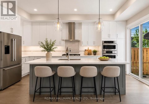 A modern kitchen with white cabinets and a large island.