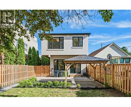 A modern house with a wooden fence in front.