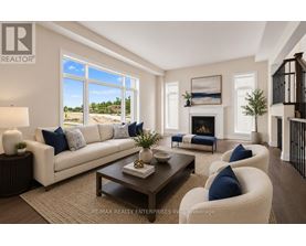 A living room with a white couch, a coffee table, and a fireplace.
