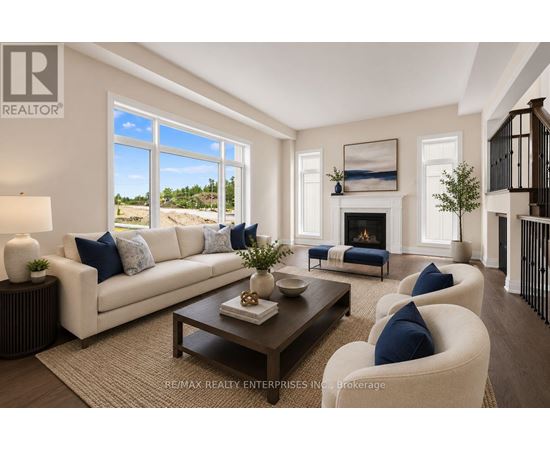 A living room with a white couch, a coffee table, and a fireplace.