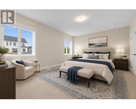 A bedroom with a large bed, a chair, and a window overlooking a house.