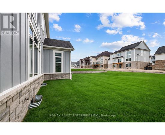 A row of houses with a grassy area in front.