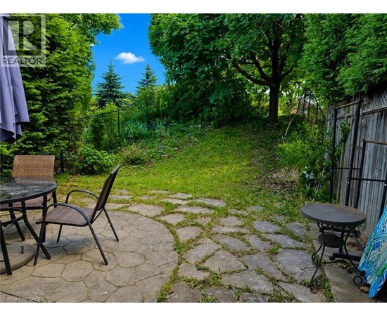 A backyard with a table and chairs.