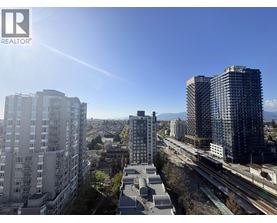A cityscape with buildings and a train track.