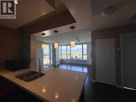 A kitchen with a sink and a window.