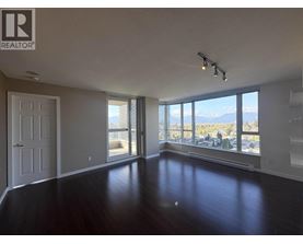 A spacious room with a view of the mountains outside the window.