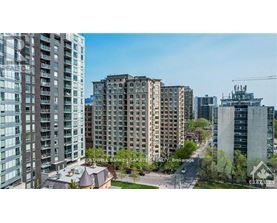 A cityscape with buildings and a clear sky.