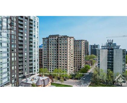 A cityscape with buildings and a clear sky.
