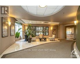 A realtor's office with a large desk and a couch.