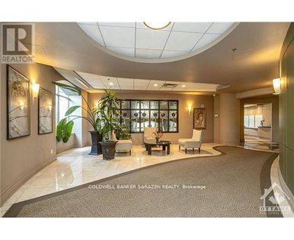 A realtor's office with a large desk and a couch.