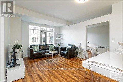 A living room with a white couch and a black leather couch.